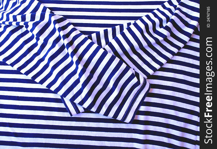 Detail of blue and white sailor's shirt before packing into a suitcase. Detail of blue and white sailor's shirt before packing into a suitcase.