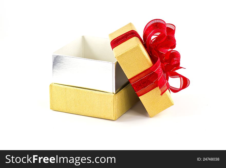 Opened gift box and red ribbon on white background