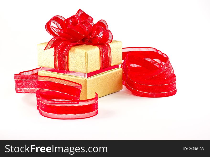 Gift box and red ribbon on white background