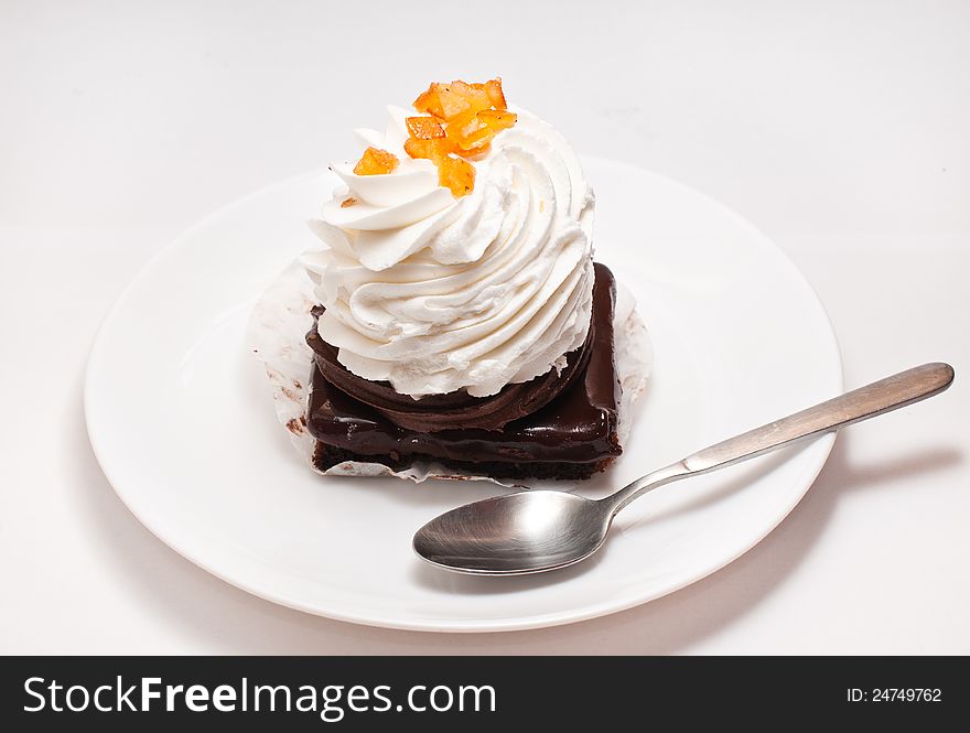 Piece of cake on white plate with spoon. Piece of cake on white plate with spoon