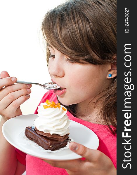 Fun teen girl eating the cake on the white background .Portrait of young woman eating cake isolated on white background