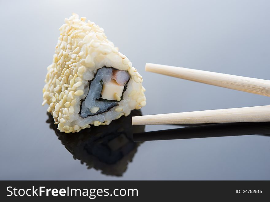 Sushi with sesame and chopsticks