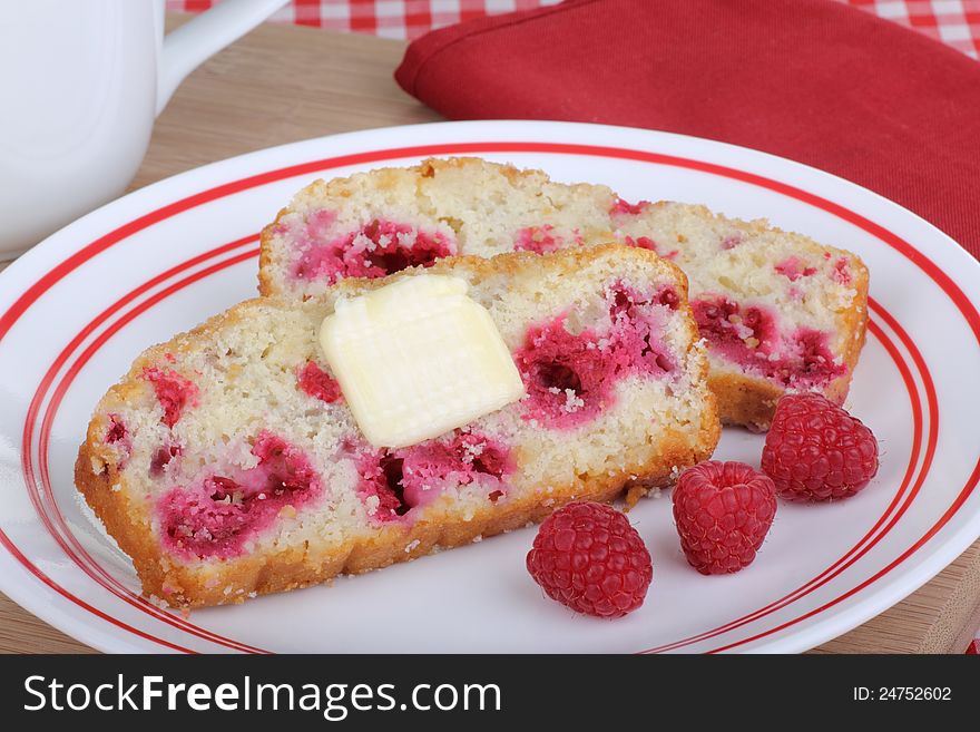 Slices of cranberry bread with cranberry fruit on a plate