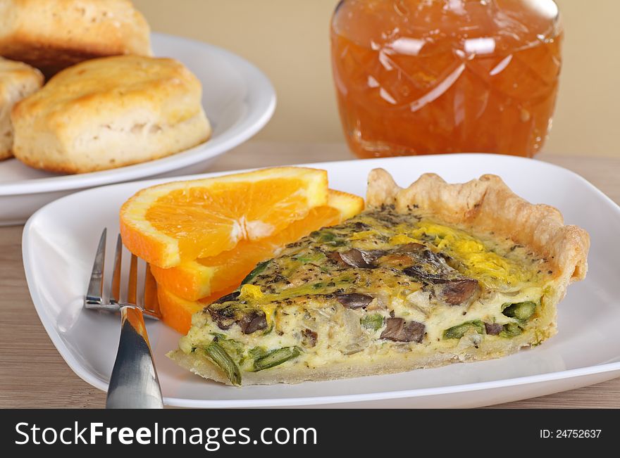 Mushroom and vegetable quiche with orange slices