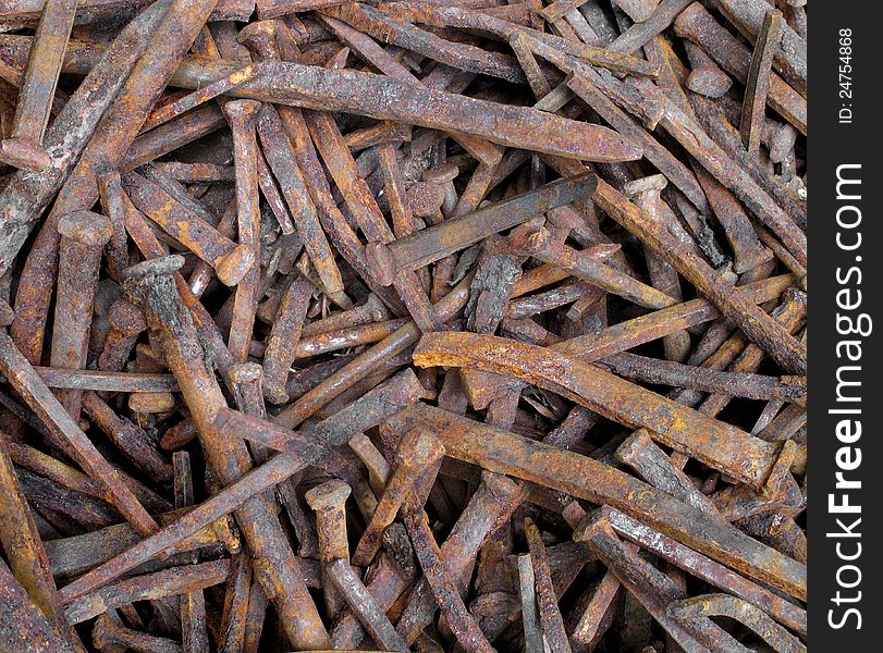 Close-up of a pile of old rusty square nails. Suitable for a background.