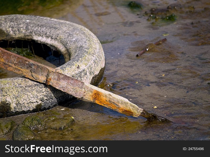 Debris in the form of old car tires and scrap metal in nature. Debris in the form of old car tires and scrap metal in nature