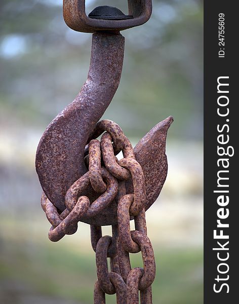 Close up of rusty hook with chain