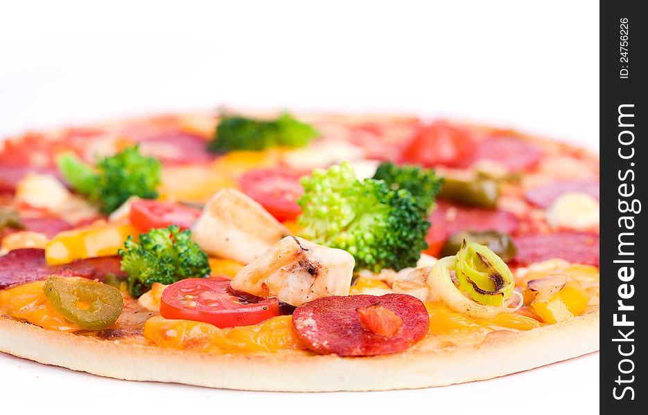 Close-up of fresh pizza with chicken and broccoli on white background