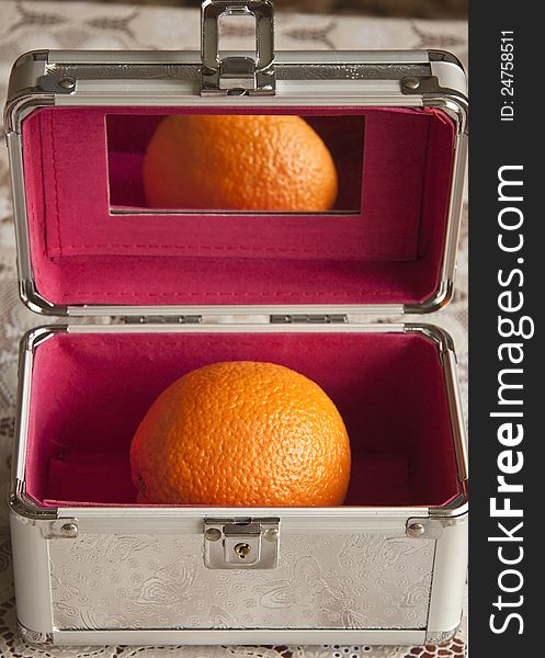 Large orange in a metal trunk. Large orange in a metal trunk