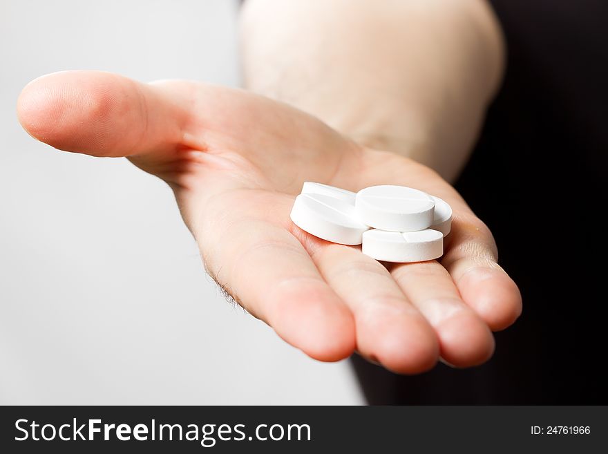 Man holding pills in hand