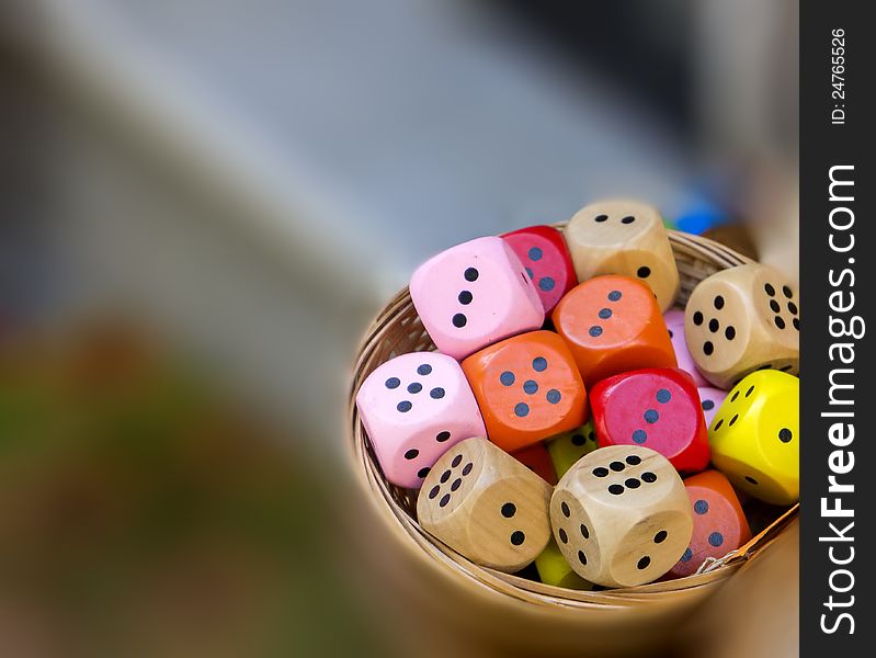 Colored dice in small basket