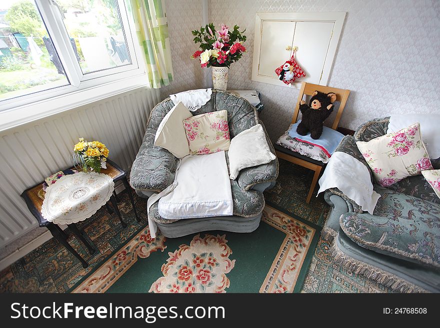 Empty armchair in an old persons home after their passing.