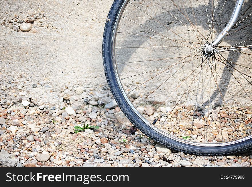 Photo of parked bicycle wheel. Photo of parked bicycle wheel.