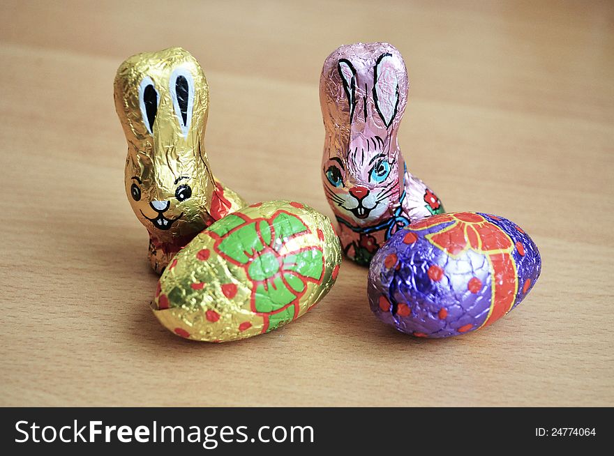 Two easter bunnies made of chocolate and two easter eggs. Two easter bunnies made of chocolate and two easter eggs.