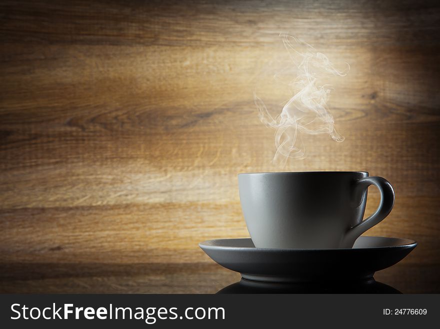 Coffee cup on wooden background