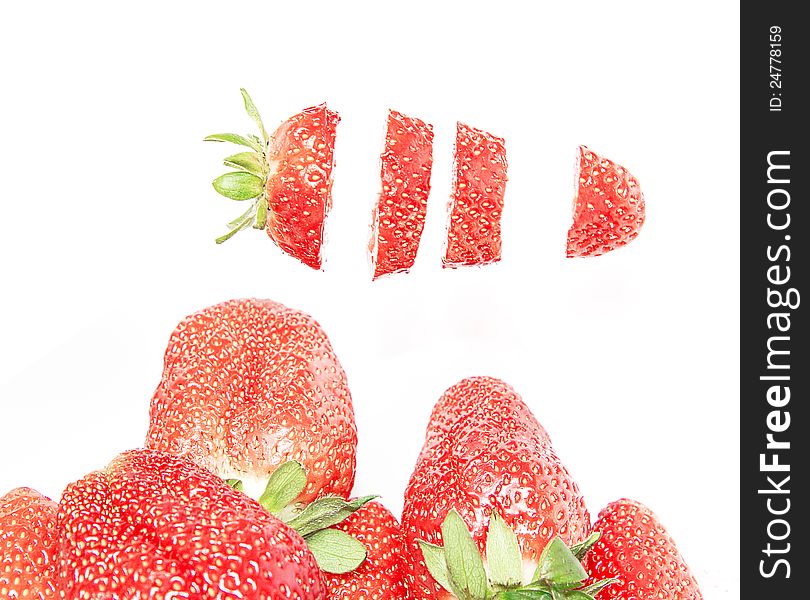 Cut strawberries isolated on white background