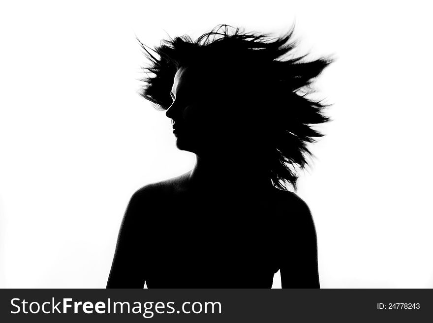 Silhouette of beautiful girl spinning her head with flying hair. Silhouette of beautiful girl spinning her head with flying hair.