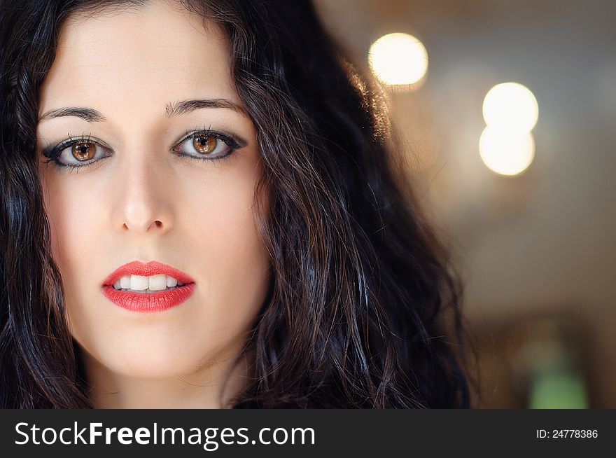 A close up of a brunette woman face, with fair, thin, smooth skin. She has brown eyes and red lips. A close up of a brunette woman face, with fair, thin, smooth skin. She has brown eyes and red lips