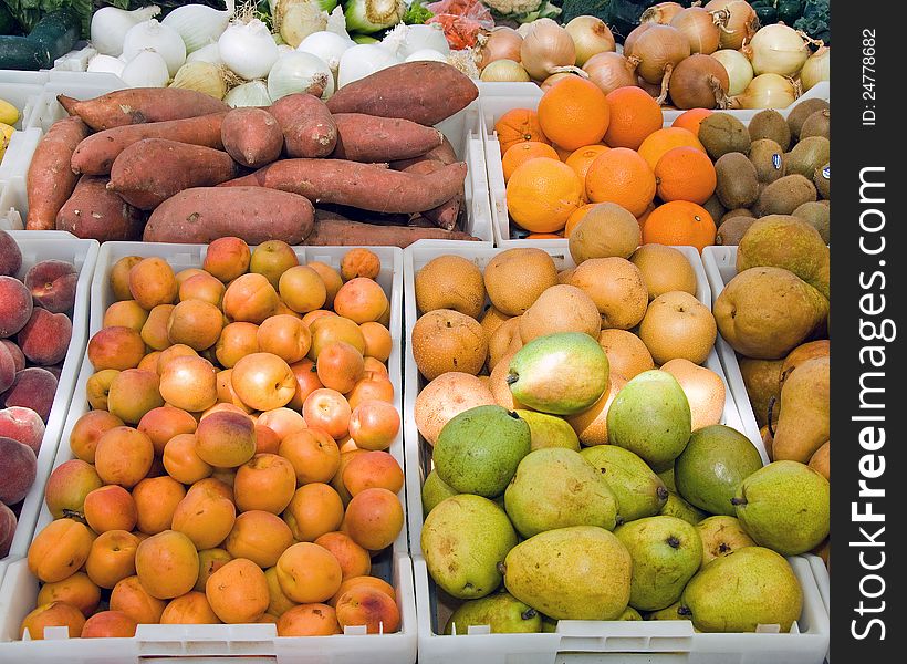 Various bins of fruits and vegetables arranged for purchase. Various bins of fruits and vegetables arranged for purchase.