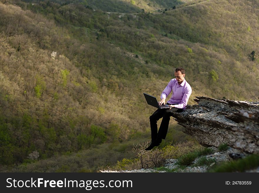 Man with notebook on stone