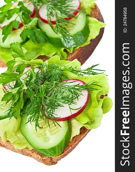 Sandwich on rye bread with herbs and vegetables on a white background, isolated. Sandwich on rye bread with herbs and vegetables on a white background, isolated.
