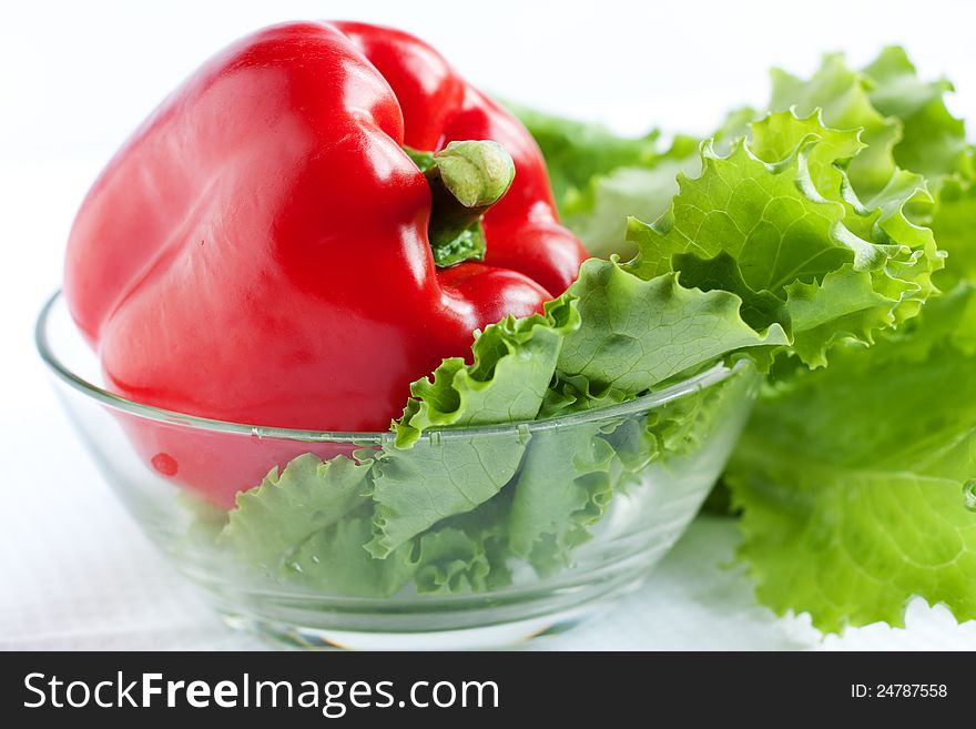 Whole fresh red pepper and lettuce