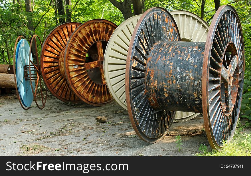 A collection of large empty industrial cable reels