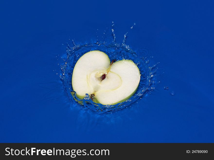 Apple fall under water with a splash