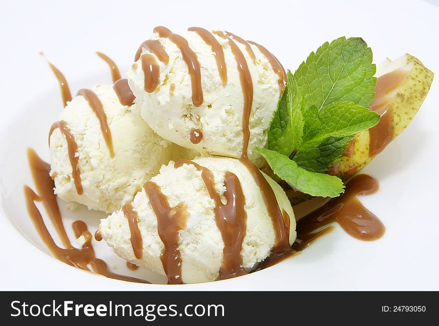 Ice cream with caramel sauce and mint on a white background