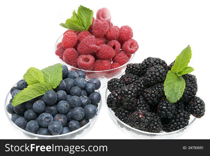 Blueberries raspberries and blackberries on a white background in the restaurant