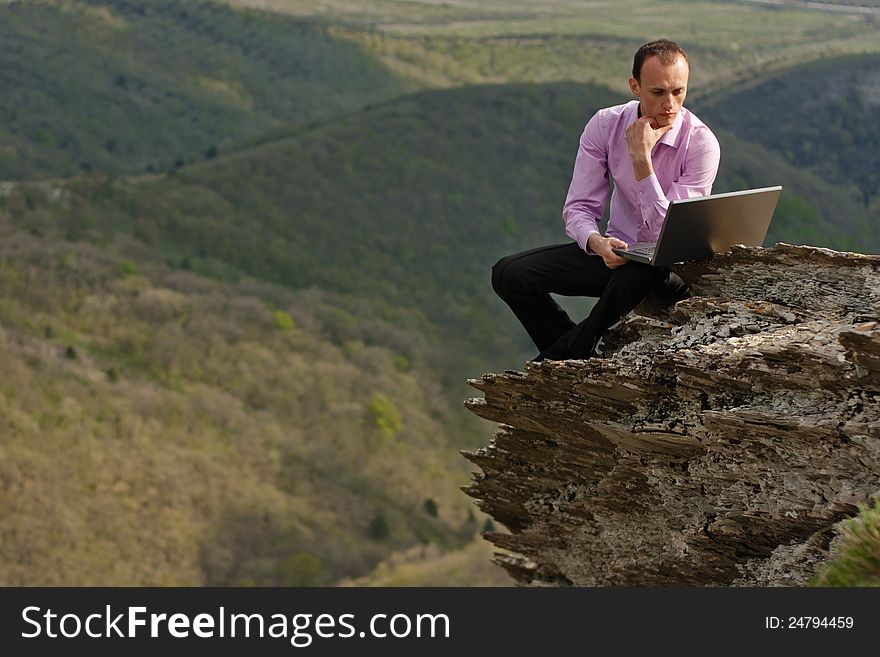 Man With Notebook On Stone