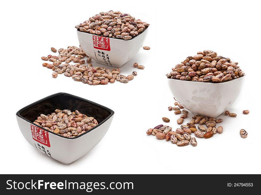 Pink haricot beans in a bowl on white background