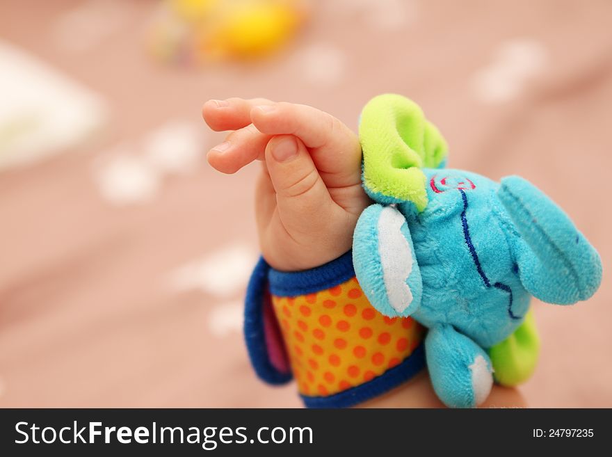 Baby hand with elephant toy