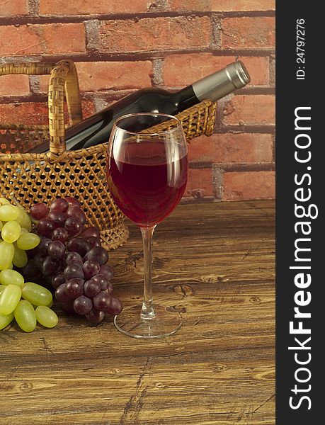 Glass of wine, bottle   and fresh grapes on a table. Glass of wine, bottle   and fresh grapes on a table.