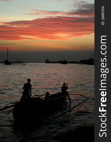 Fishermen going home during sunset. Fishermen going home during sunset.