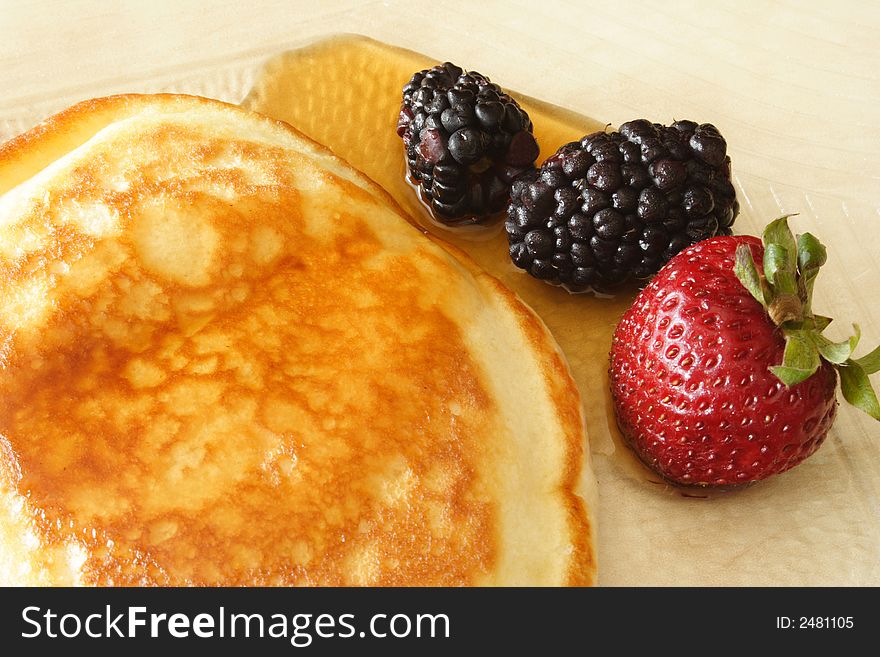 Pancake and red fruits with syrup. Pancake and red fruits with syrup