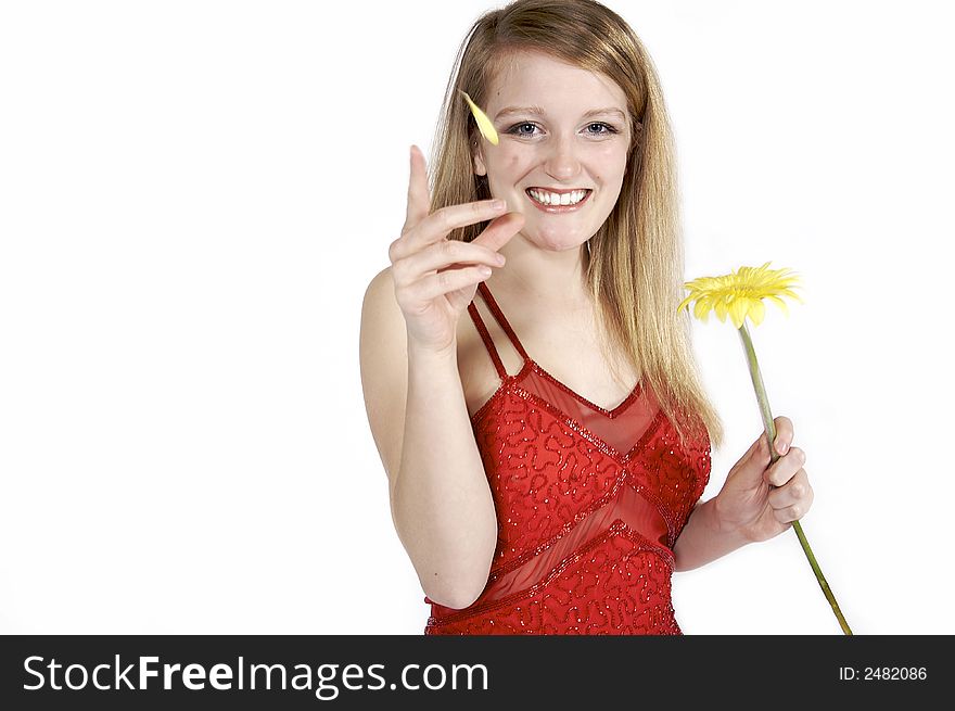 Attractive blond picking petals from a daisy. Attractive blond picking petals from a daisy