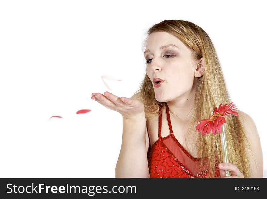 Attractive blond blowing petals from a daisy