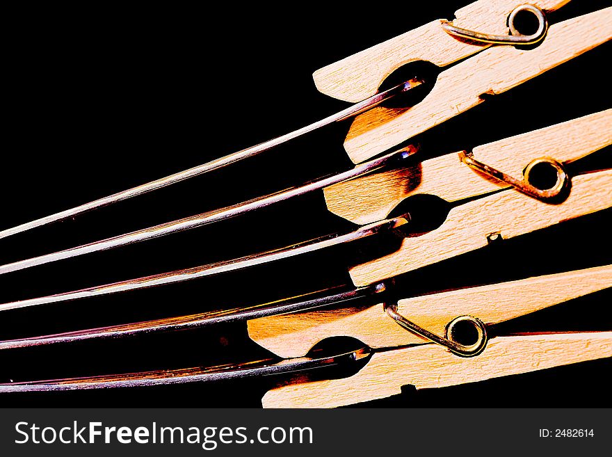 Linen wooden clips on spoons, (studio, halogen light). Linen wooden clips on spoons, (studio, halogen light).