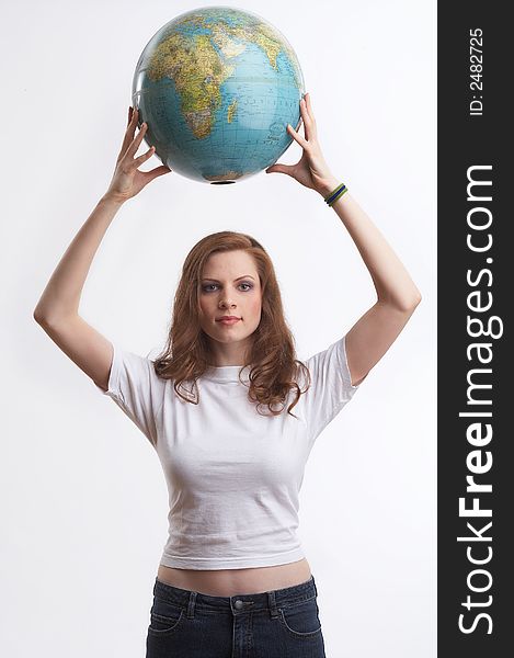 One young woman with a white shirt is holding a globe. One young woman with a white shirt is holding a globe