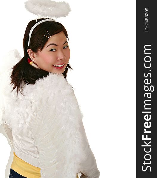 Isolated asian girl wearing angel wing and looking to her back to camera with big smile. Isolated asian girl wearing angel wing and looking to her back to camera with big smile