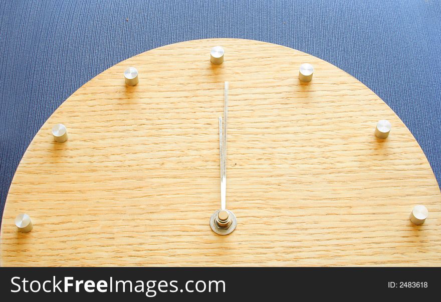 Wooden clock on a blue background. Wooden clock on a blue background