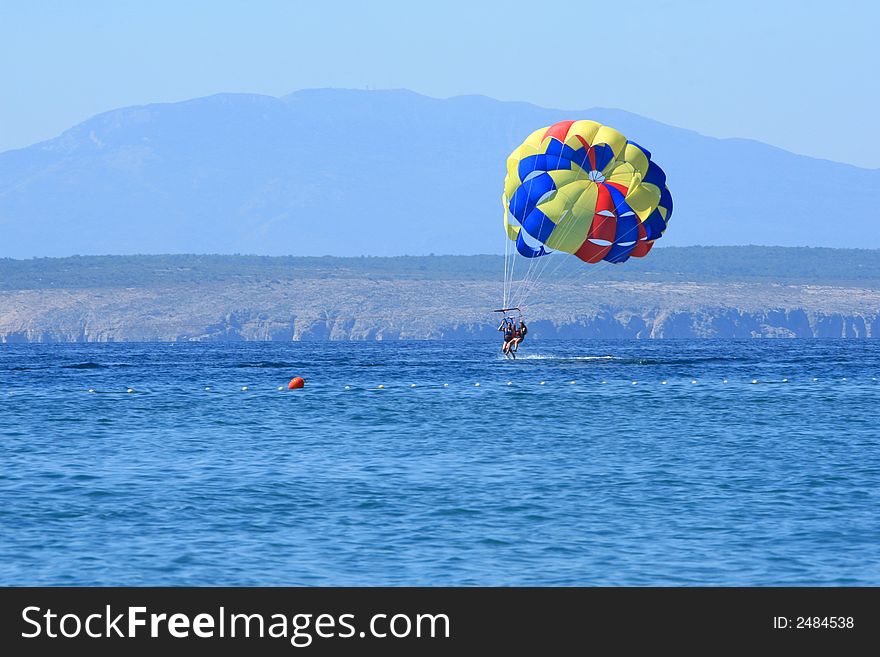 Couple parasailing above the sea