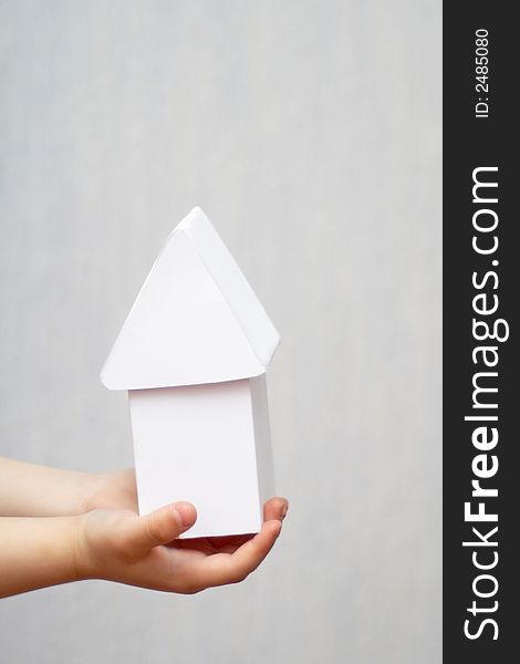 A model of a house in hands. A model of a house in hands