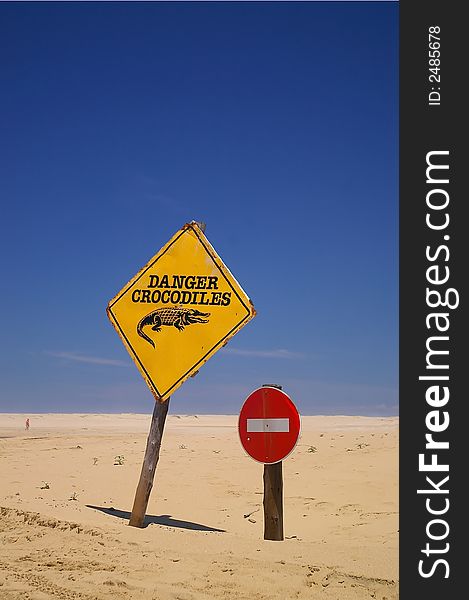 Warning and no entry sign on beach. Beware of Crocodiles. Warning and no entry sign on beach. Beware of Crocodiles