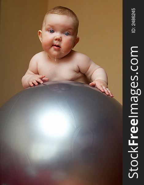 An image of a baby on the big ball. An image of a baby on the big ball