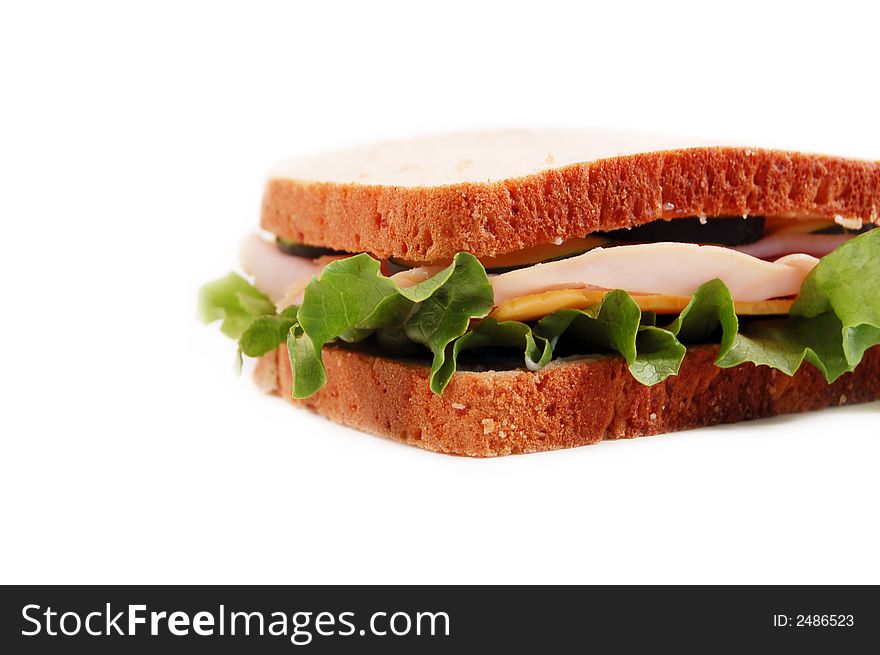 Turkey sandwich on whole wheat on a white background. Turkey sandwich on whole wheat on a white background