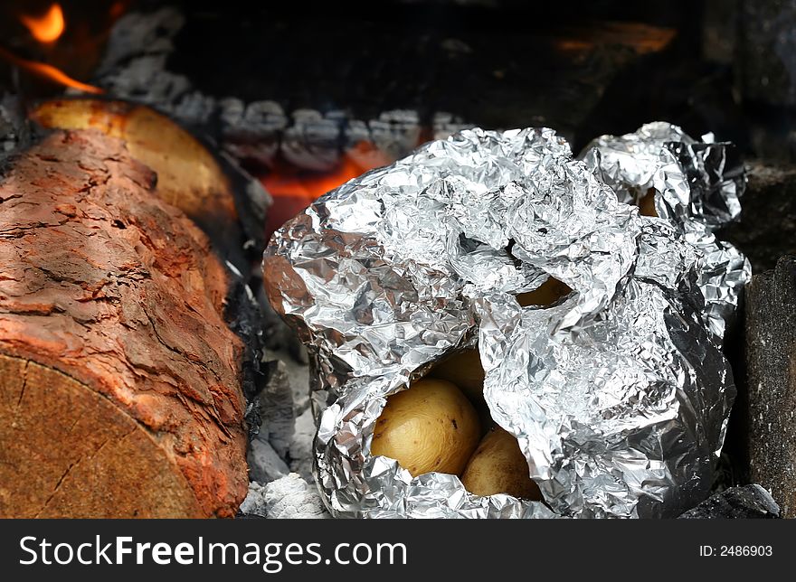 Roasting potatoes on outdoor barbecue grill. Roasting potatoes on outdoor barbecue grill