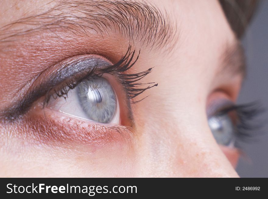 An image of expressive blue woman's eyes. An image of expressive blue woman's eyes