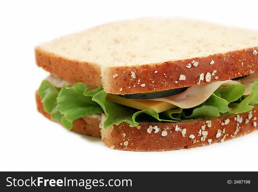 Turkey sandwich on whole wheat on a white background. Turkey sandwich on whole wheat on a white background
